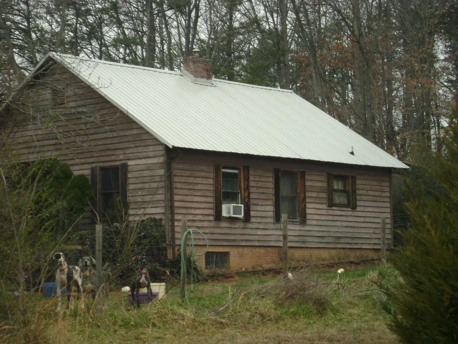 White metal roof on an old wood sided farmhouse, from a Metal Roof Installation job in O Brien